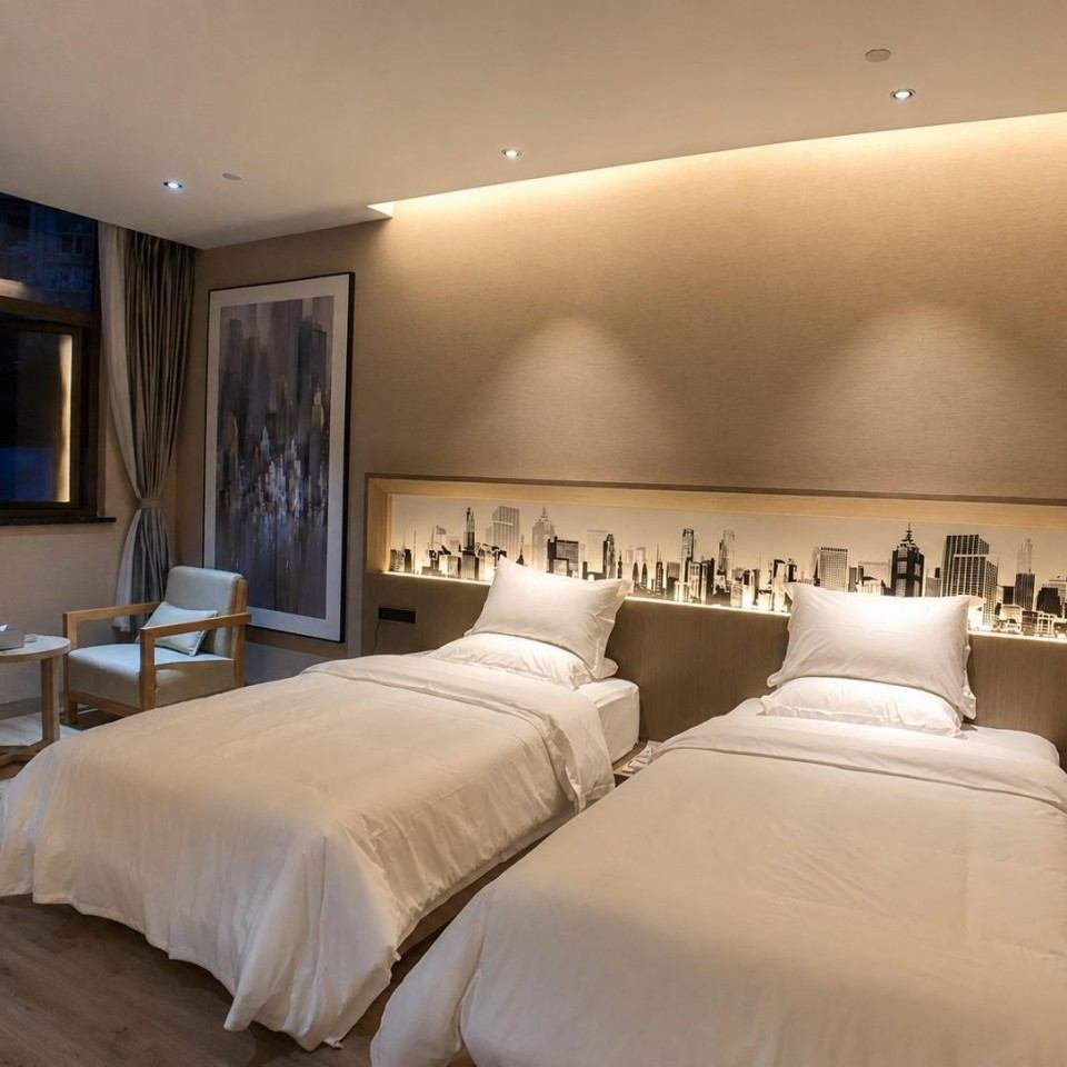 Xikelai Hotel guest room with bedside wall panel