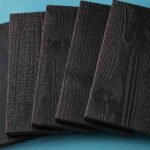 Carbonized wood finish samples with dark textured grain surfaces