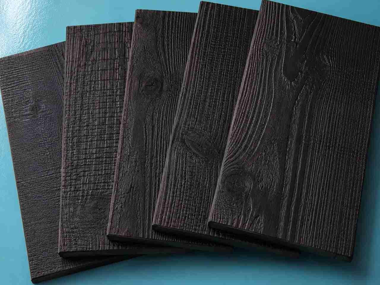 Carbonized wood finish samples with dark textured grain surfaces