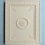 Carved relief cabinet door panel with floral decorative details