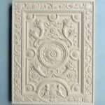 Carved relief cabinet door panel with ornate floral and classical decorative details
