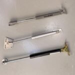 Gas struts for lift-up cabinet door support