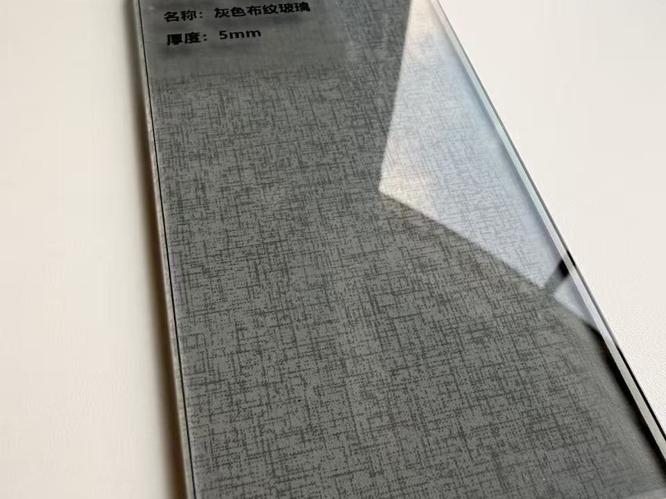 Grey fabric-texture glass surface with translucent finish