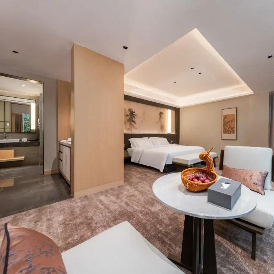 Namu Lake Resort Hotel guest room with bed and seating area