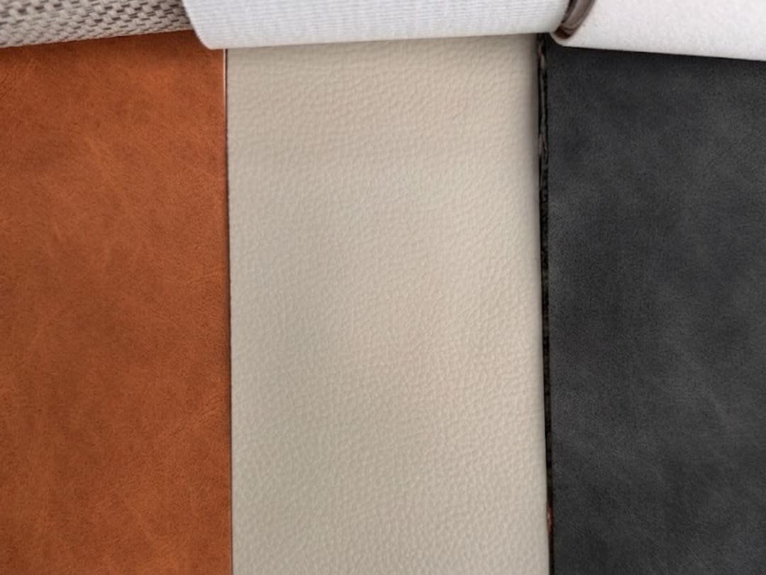 Leather finish samples in brown, cream, and black colors