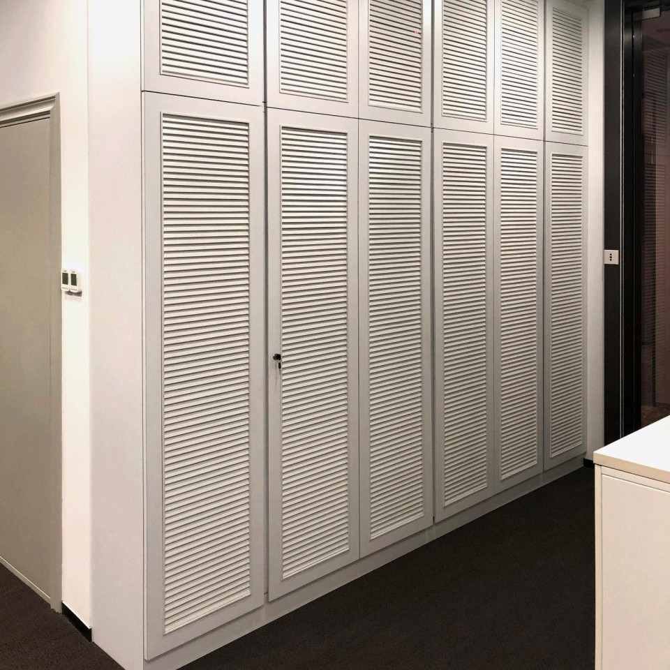 Standard Chartered Bank louvered door cabinet in commercial office space