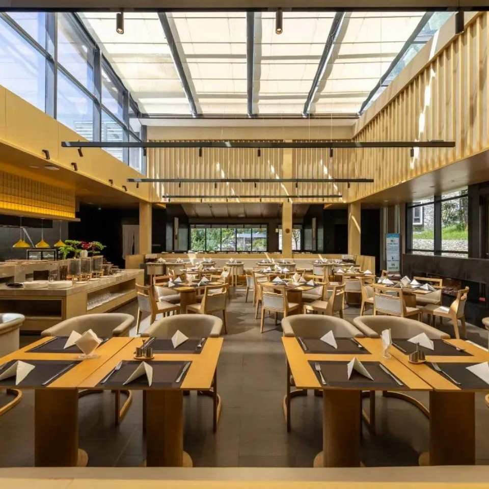 Namu Lake Resort Hotel restaurant area with dining tables and wood interior