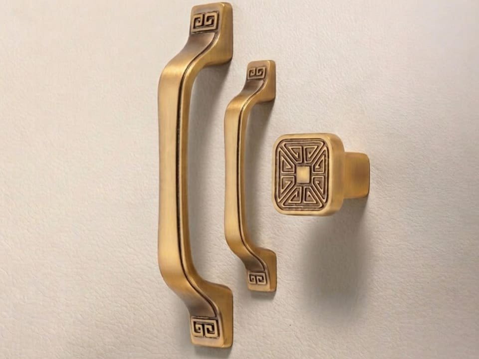 Surface-mounted cabinet pulls in antique brass finish