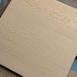 Wood veneer finish sample with light natural grain texture