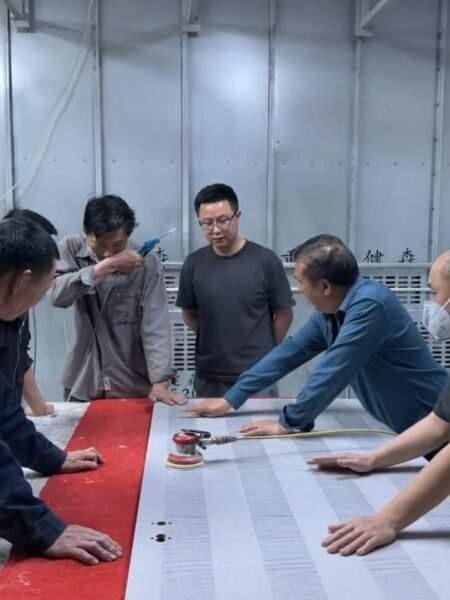 Horace Home team checking woodwork production details in the workshop