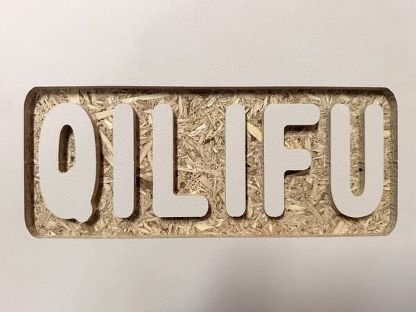 OSB display sample with routed lettering and exposed wood strand structure